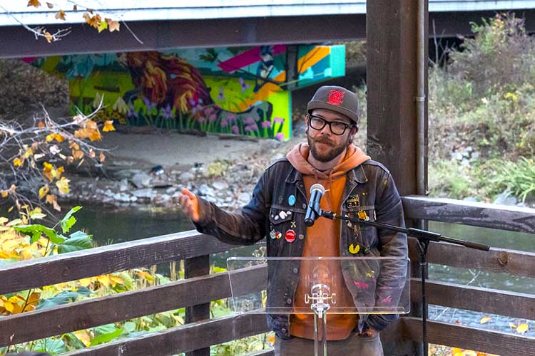 Arlin Graff speaks at the mural's unveiling at the May Barn at CVNP